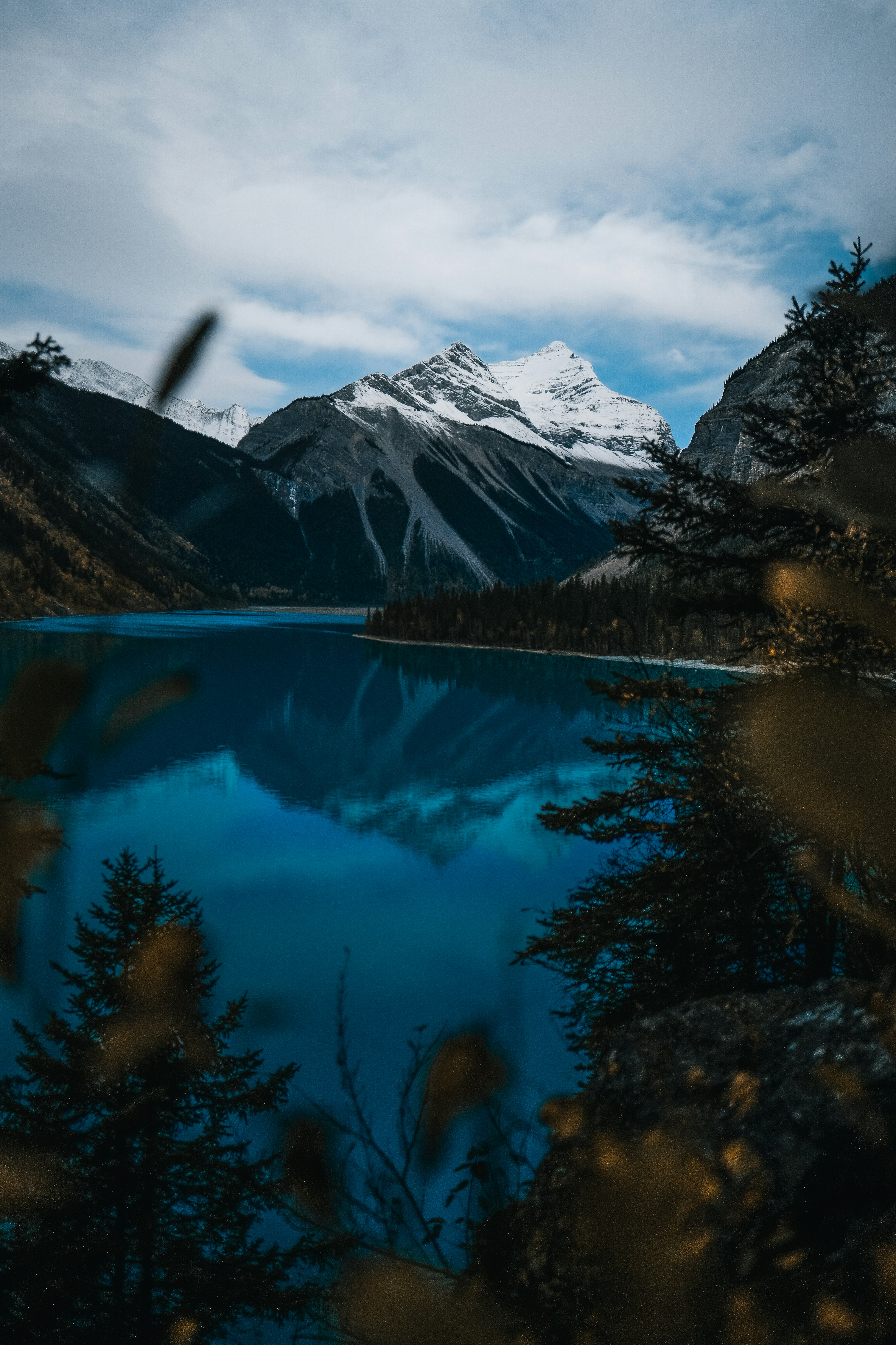 body of water near snow-covered mountain during daytime